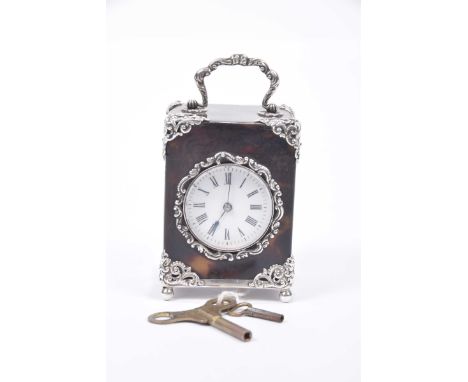 A late 19th Century French tortoiseshell and white metal applied ladies miniature carriage clockWith a central circled white 