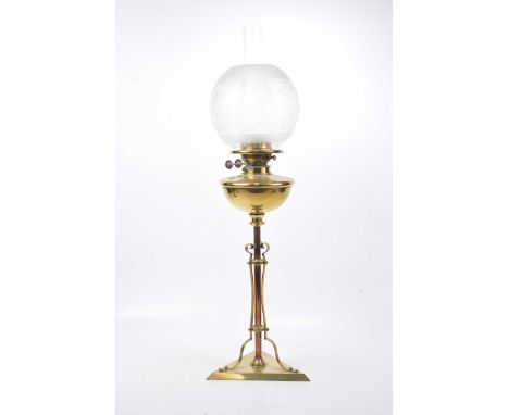 An Art Nouveau copper and brass oil lamp Triangular base extending to a central stem, with domed oil receptacle with frosted 