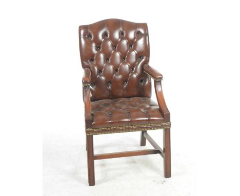 A reproduction brown leather club chair With an arched padded button back above padded arms raised upon down swept supports, 