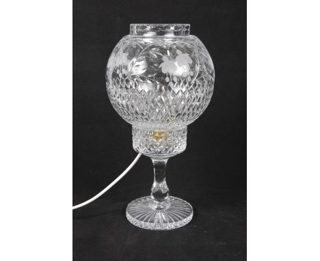 A cut glass globe shaped table lamp, 20th Century
The shade with etched decoration of fuchsias, height 36cms. (sold electrica