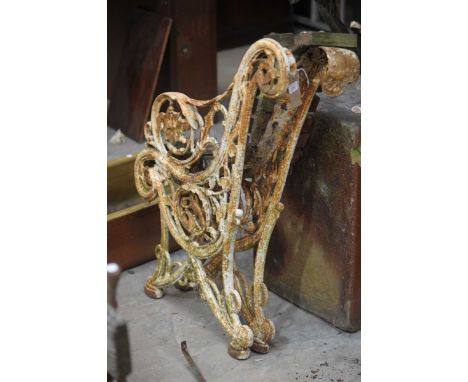 A pair of painted iron bracket supports of open work scrolling form.
