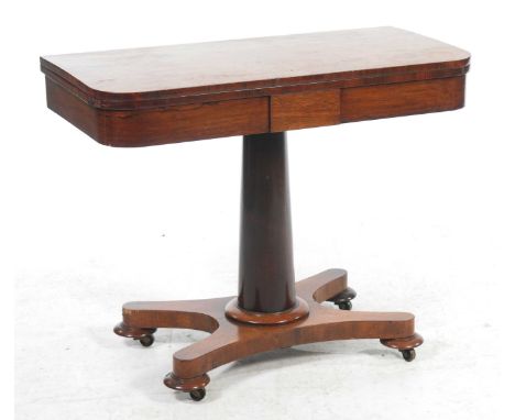 A mid 19th Century rosewood pedestal games table
The rectangular folding top with a baize lined playing surface and rounded c