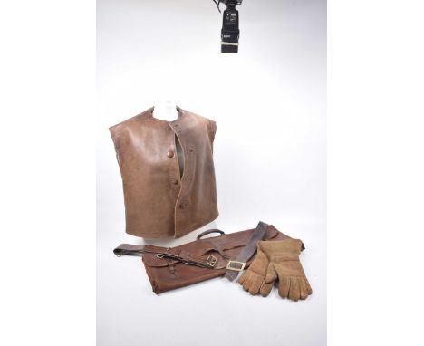 A quantity of vintage leather items
To include a tan leather shooting waistcoat, a tan leather gun sachet with tool initials 