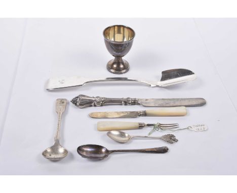 A collection of Georgian and Victorian silver items To include a Stilton scoop, an egg cup, a miniature mother of pearl handl