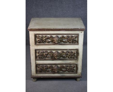 A cream painted chest of three long drawers, both sides with six panels, each panel with a mirrored border, the drawers with 