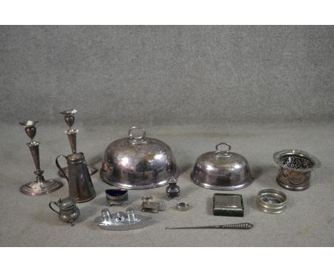 A collection of pewter and silver plate, including a pair of Victorian silver plated candlesticks, a chrome ship design cruet