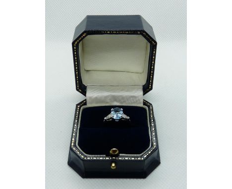 Good Quality Ladies 18ct White Gold Ring with Oval Claw set Blue Topaz 1.8ct flanked by Pear shaped Diamond shoulders total 0