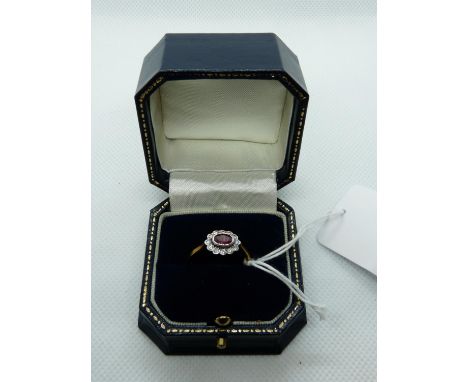 Oval 9ct Gold Edwardian Style Ring with Rub-over set oval Ruby surrounded by Rub-over set Diamonds, 3.1g total weight. Size Q