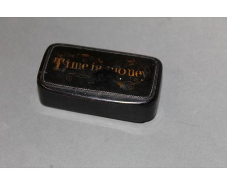 An early 19th century black papier-mache snuff box, the lid worded in gilt "Time is Money"