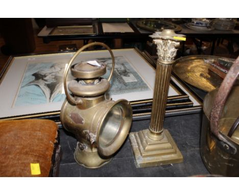 A late 19th/ early 20th century car side lamp together with a brass Corinthian column candlestick 