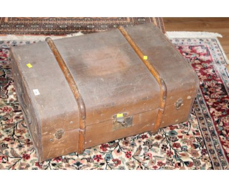 A late Victorian canvas and wood bound travelling trunk, one side with lozenge shaped elephant pattern manufacturer's logo an