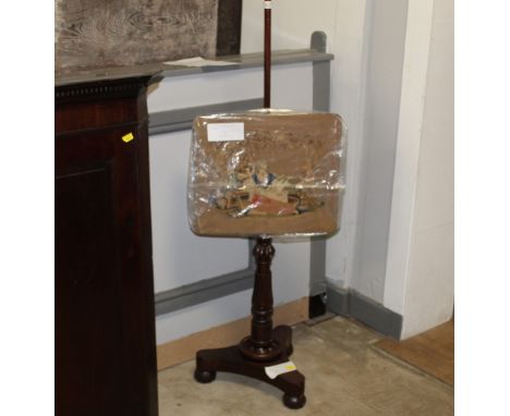 A Victorian mahogany tapestry pole screen measuring 130 cm tall 