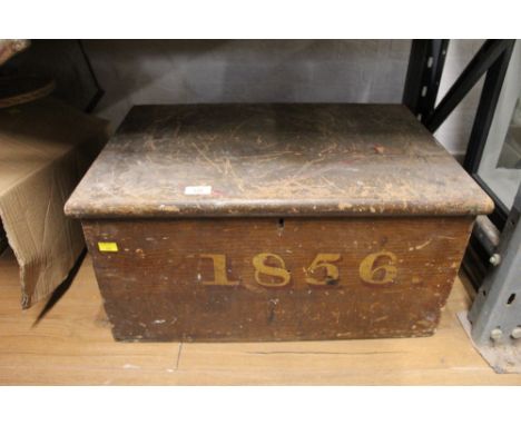 A Victorian pine trunk inscribed "1856" and containing wood planing tools 