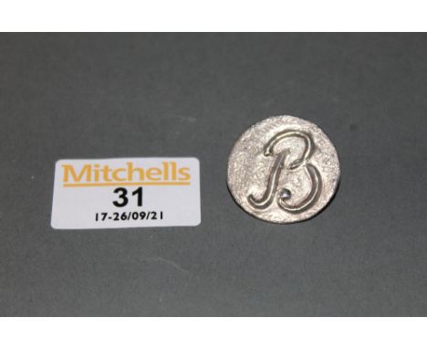 A silver button embossed with initial B hallmarked for Chester 1946