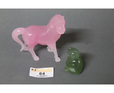 A rose quartz carving of a standing horse together with a jade cat