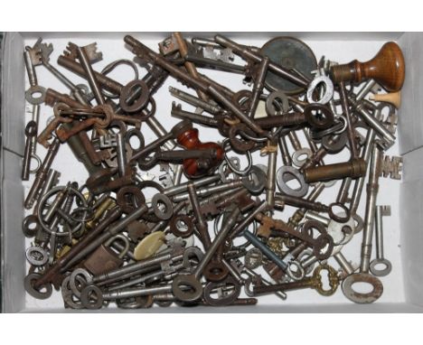 A box of mixed keys together with a long case clock winding handle 