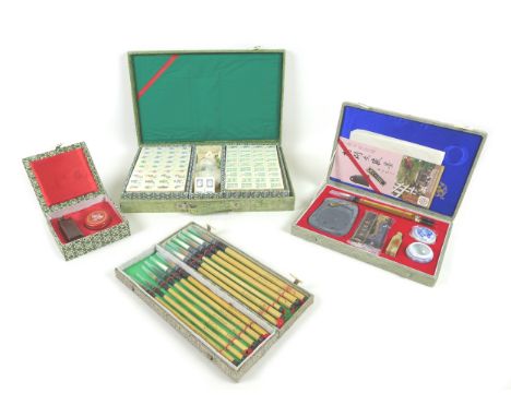 A collection of 20th century Chinese collectables, including a cased Mahjong game, a boxed group of 12 calligraphy/paint brus