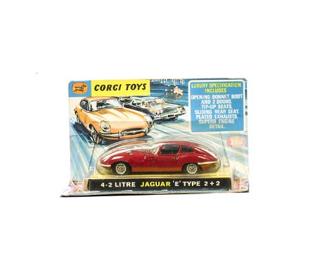 A Corgi Toys 335 Jaguar 4.2 Litre E-Type, dark red body, black interior, spoked wheels, in original bubble pack, E, box F, la