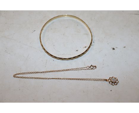 A 9ct gold opal set pendant hung to a fine link chain, approx. total weight 1.5gms and a 9ct gold bangle with bronze core