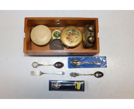 A box containing souvenir spoons, compacts, alarm clock, travelling clock etc.