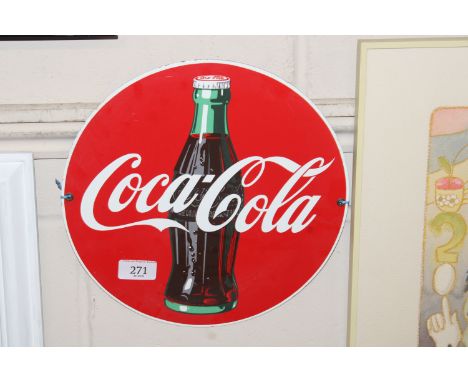 A circular reproduction enamel Coco-Cola advertising sign