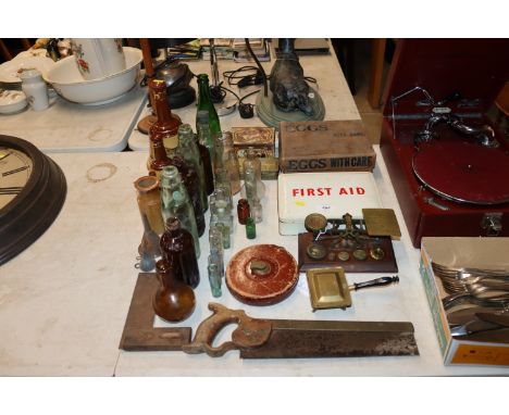 A vintage cardboard egg box; a vintage First Aid tin; a collection of various old bottles; Wade whisky decanters; surveyors t