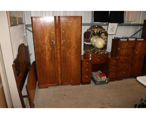 An Art Deco walnut bedroom suite comprising tallboy, pedestal dressing table, double wardrobe and bedstead (wardrobe having l