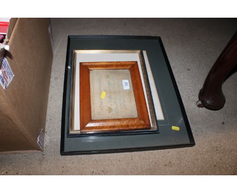 A small Victorian sampler in maple frame; and two black and white prints of street scenes