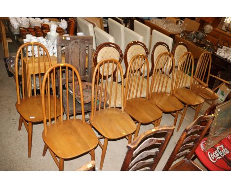 A set of seven Priory stick back kitchen chairs, six standards one elbow