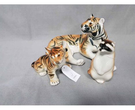 LOT OF CERAMIC ANIMAL FIGURESRussian, comprising two tigers, panas, one seal, polar bear, badger, racoon, and dog (9)