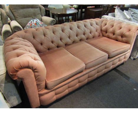 An Edwardian button back Chesterfield three seater sofa on bun feet and castors, 198cm long x 68cm tall x 86cm deep  