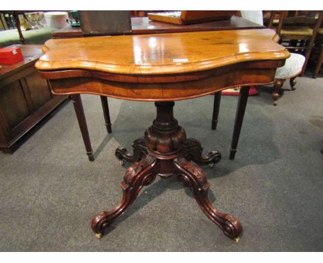 Circa 1840 a figured walnut serpentine front, hinged swivel top card table over a turned and melon fluted carved column with 