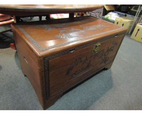 A mid 20th Century Southeast Asia camphor wood trunk with carved decoration and sliding tray (with lock), 101cm x 55cm x 56cm