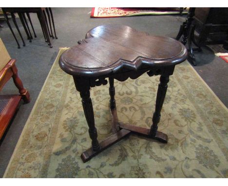 An Edwardian oak clover leaf top lamp table on turned and carved tri-legs with sledge feet base, 65cm x 52cm       