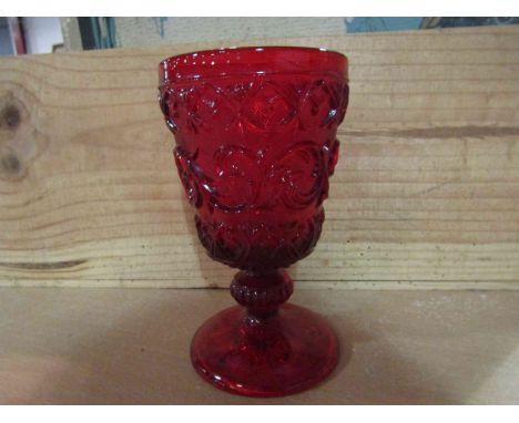 A pressed glass water goblet, the ruby red bowl with raised decoration, 15cm tall       