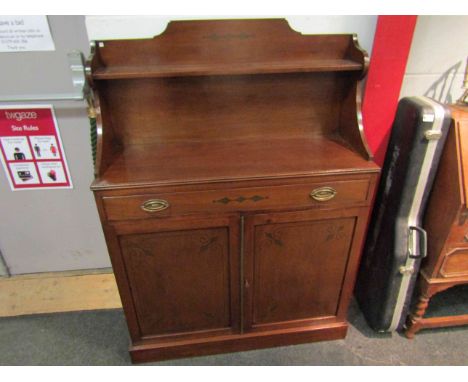 A Regency style mahogany chiffonier with raised shelf back and holly inlaid decoration the single drawer over a two door cupb