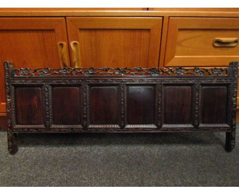 A 19th Century Oriental six-field hardwood panel, with a carved and pierced cresting of prunus and foliate edges (cut from so