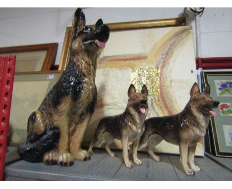 Three ceramic Alsatian dogs, tallest 49cm