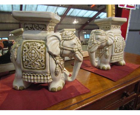 A pair of ceramic elephant form jardiniere stands