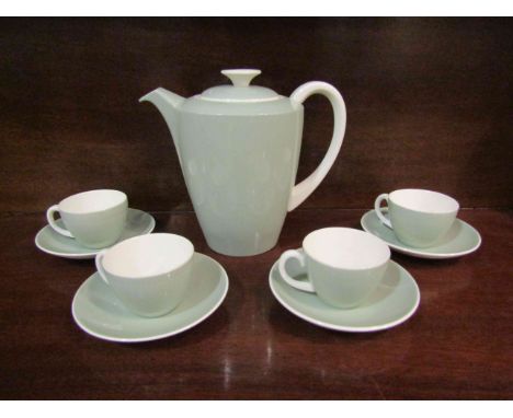 A Poole pottery mint coloured part coffee set comprising of coffee pot  and four cups and saucers