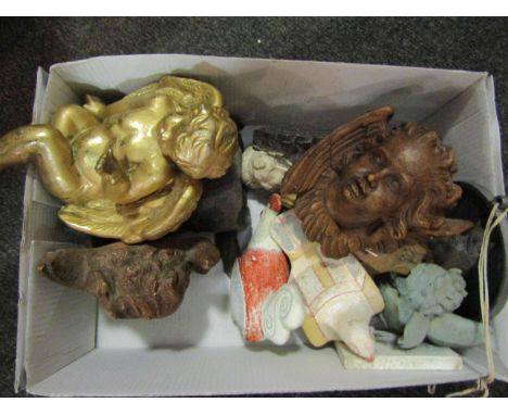 A box of curios including pottery figures, cherub masks, glass cat panel etc