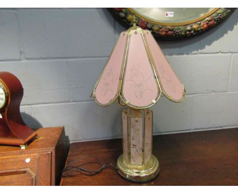 A brassed table lamp base with pink glass floral panels