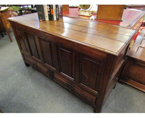 A 17th Century pegged oak five panel mule chest, the hinged three plank lid over two base drawers on stile feet, 141cm wide x