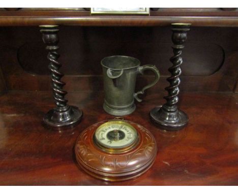 An early 20th Century mahogany wall barometer, a pair of barley- twist candlesticks and a pewter ale pourer (4)