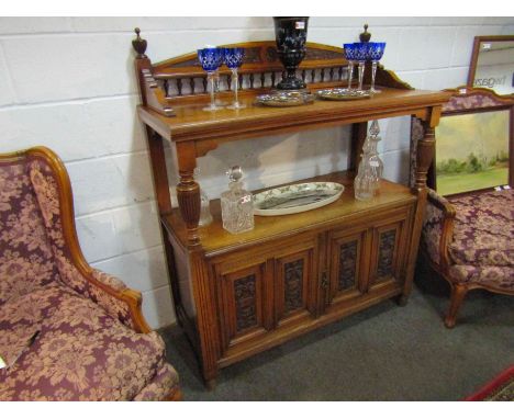 A Victorian wanlut two tier serving table/buffet with raised gallery back, fluted columns and carved foliate panel doors