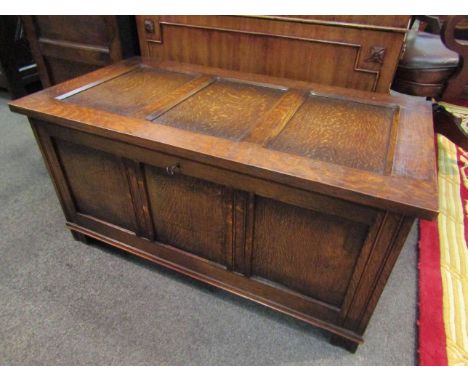 A 17th Century style oak three panel coffer with lined interior and key over stile feet, 97cm x 51cm x 48cm       