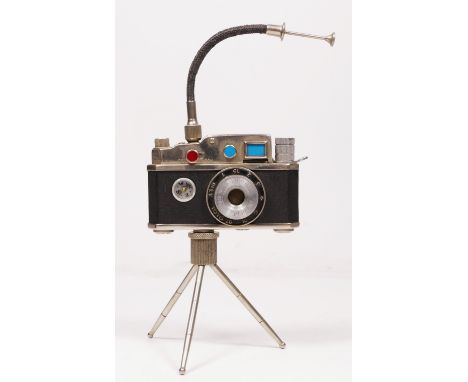 A vintage novelty Photolite Japanese cigarette lighter in the form of a miniature camera complete with miniature tripod and c