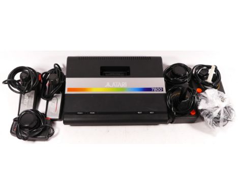 A Atari 7800 console (serial No X9383802185), with power cable, two joysticks, two Atari driving controllers and two Atari tw