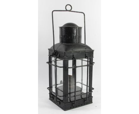 A hand lantern in protective metal cage with burner 