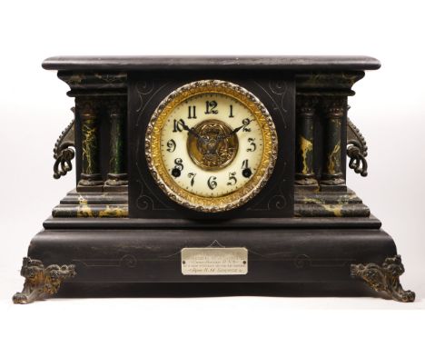 Of HMS Ganges interest; an imitation black slate and marble mantel clock, with presentation plaque, the American movement str